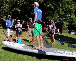 Instructor demonstrating paddling a stand up paddleboard